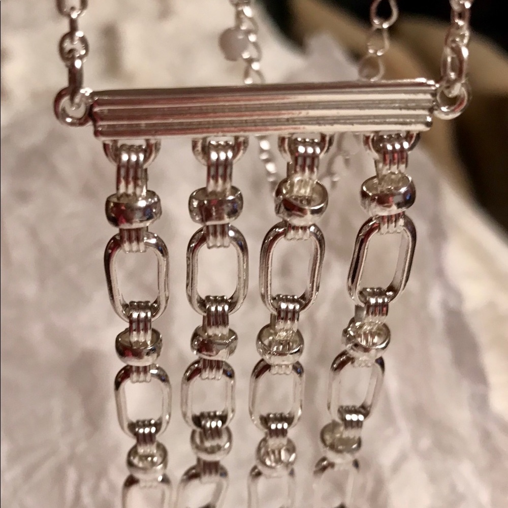 Beautiful long silver tone necklace.